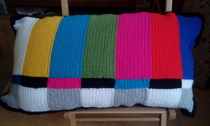 A crocheted cushion, designed to look like a modern television test card.