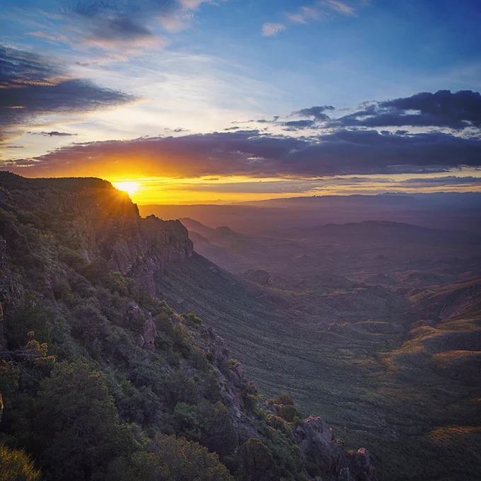 Sun peeks over the ridge