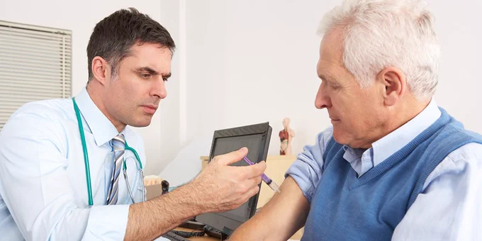Doctor giving an older man a vaccine injection