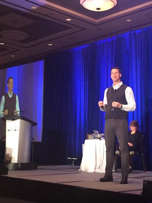 Mark Tewksbury and Debbie Muir on stage at the EQAO Forum.