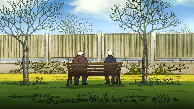 Two elderly men sitting on a courtyard bench on a serene day