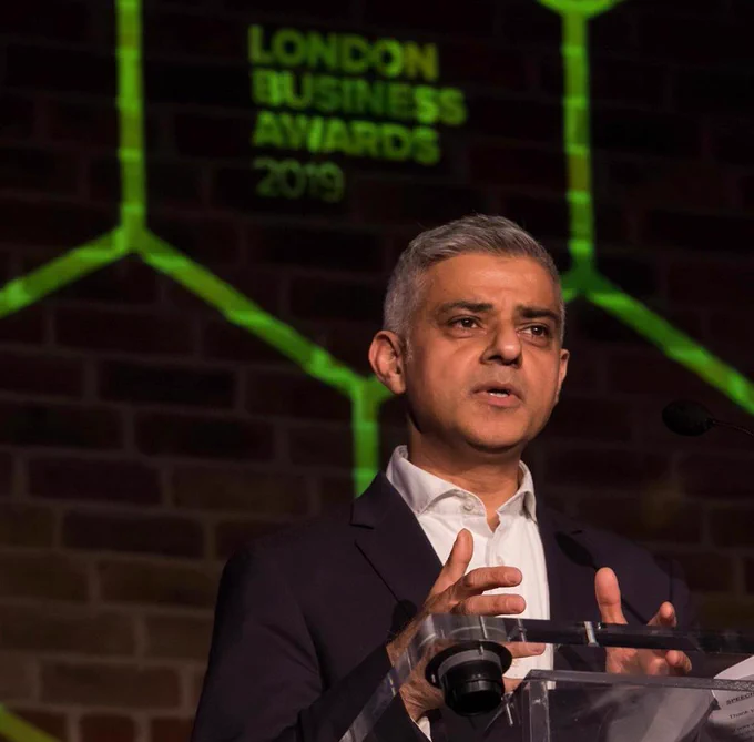 Sadiq Khan standing behind lectern giving a speech.