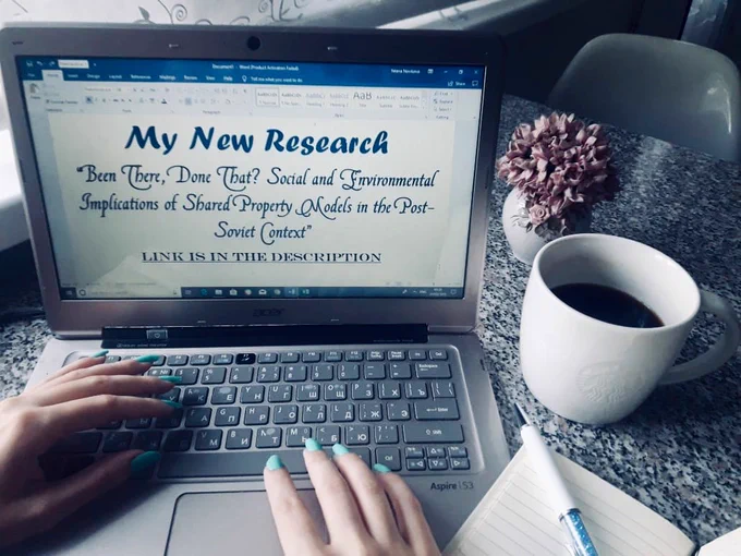 Working moment, a woman at her desk typing on her laptop: “My New Research. “Been There, Done That: Social and Environmental Implications of Shared Property Models in the Post-Soviet Context” Link in the Description”
