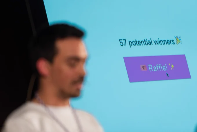 Tiago doing a live raffle on stage at typeof conf