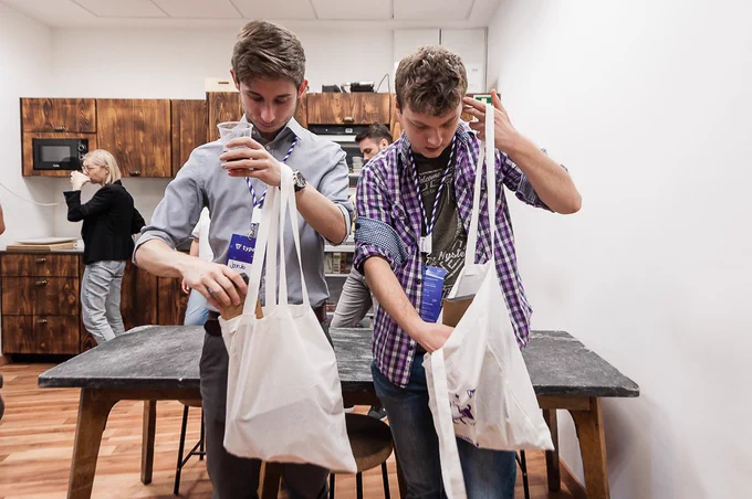 People looking through their typeof tote bags swag during workshop day