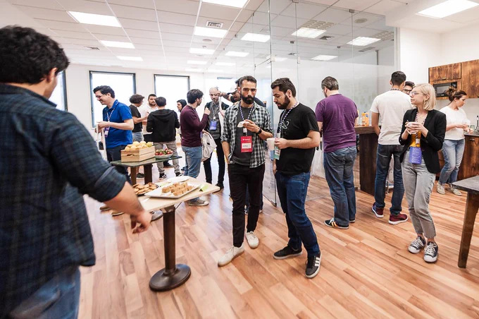 People having snacks in Mindera's office during coffee break at workshop day of typeof conf