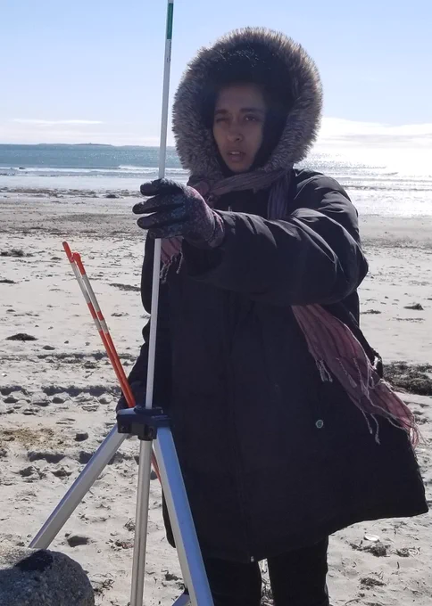 Vidya helping do research on the beach in winter.