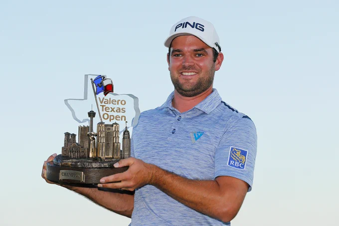 Corey Conners holding trophy