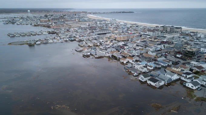 aerial image of flooding behind buildings on coast; photo taken by Will Brown
