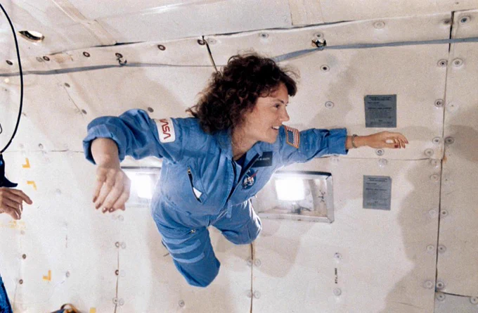 Teacher in Space astronaut Christa McAuliffe floats inside of an aircraft during a microgravity training flight