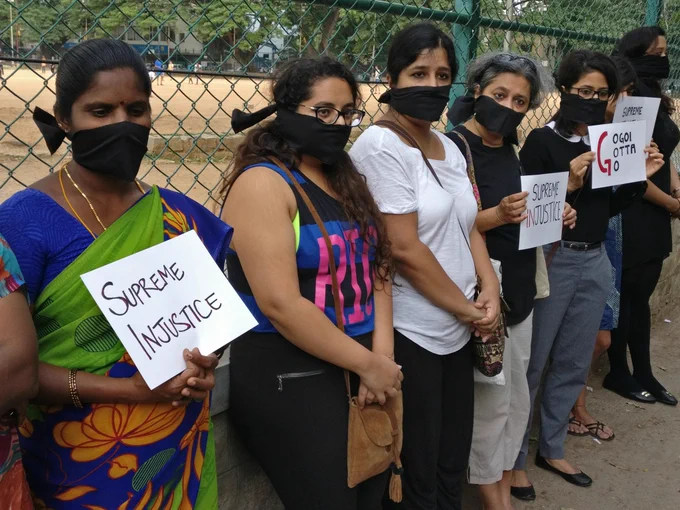 Women standing with gagged mouths and protest symbols