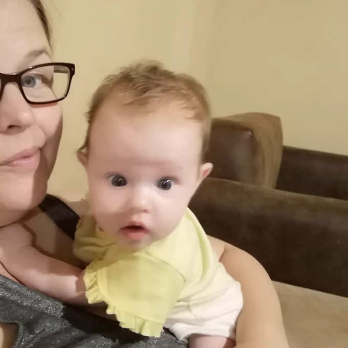 3 month old girl staring in awe at the screen.