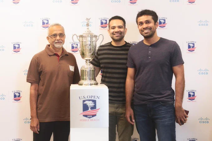 Cisco employee and family taking a photo with the US Open trophy