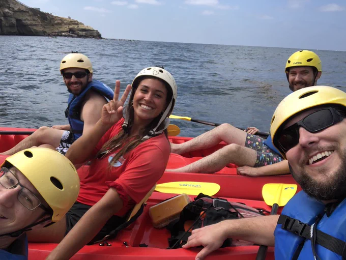 A group of attendees happily posing during the 2018 JSConf US sea kayaking activity in La Jolla