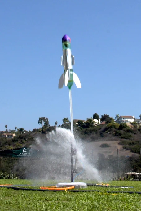 A pressurized water fueled rocket takes off from the launchpad lifting its JavaScript-based payload hundreds of feet into the air