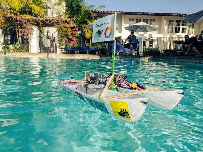 A hand-built JavaScript-powered, remote controlled boat out at sea in the hotel's kiddie pool