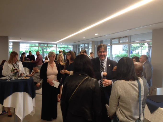 St. Michael's president David Sylvester chats with guests at the graduand reception.