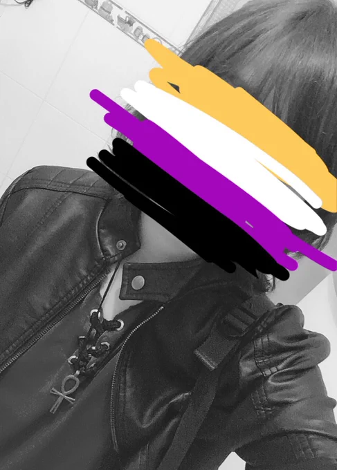 a black and white selfie of mine with the non binary pride flag scribbled on my face covering it