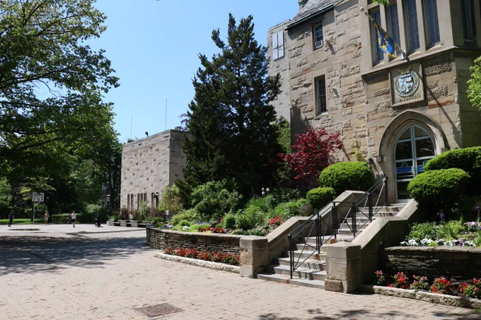 A view of Brennan Hall with a basketball half-court in the background.
