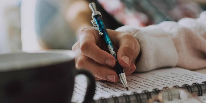 Person writing in a notebook