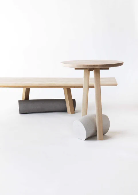 A wooden bench and coffee table with grey marble features