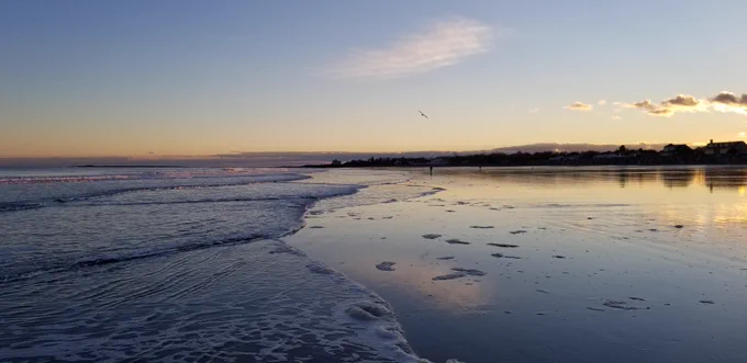 coastal beach with ocean and sand at sunrise