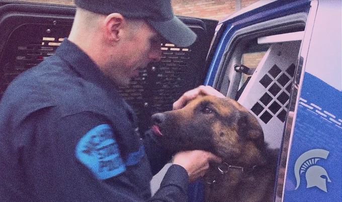 An officer petting one of the canine cops