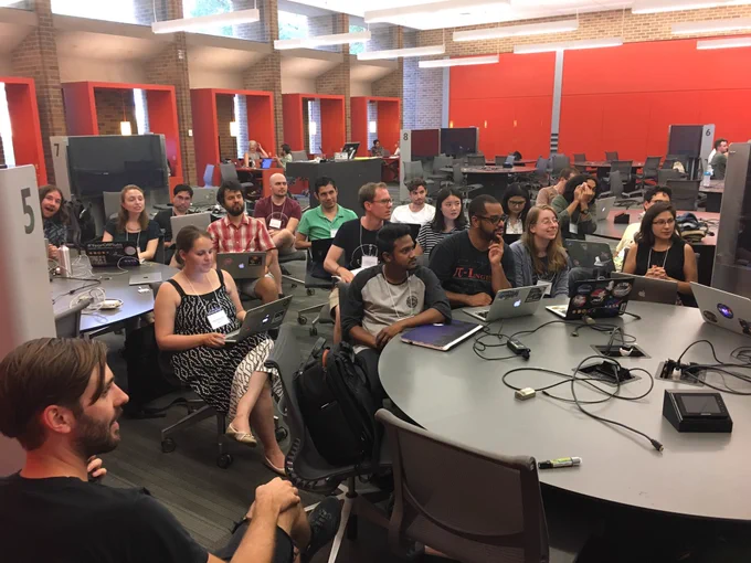 Attentive group of people with laptops at circular tables (all three images are similar)