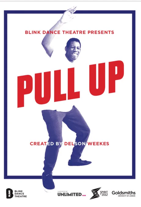 Delson is standing in a bold position with one arm up and a big smile against a white background with the PULL UP logo going across his chest.
