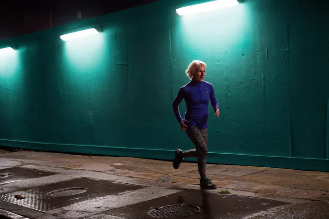 A woman running at night.