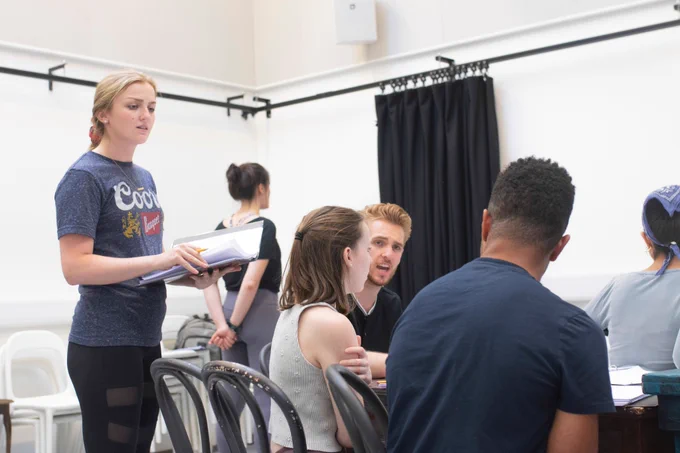 Students sitting at a table during rehearsals for Limbo: The Twelve