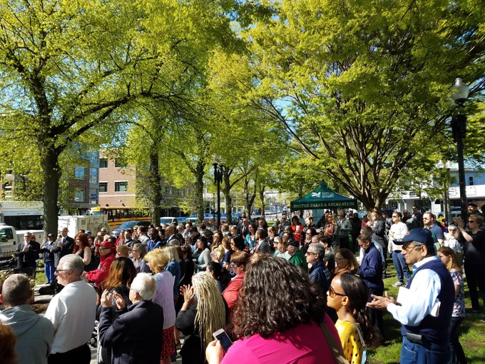 A group of people gathering and listening