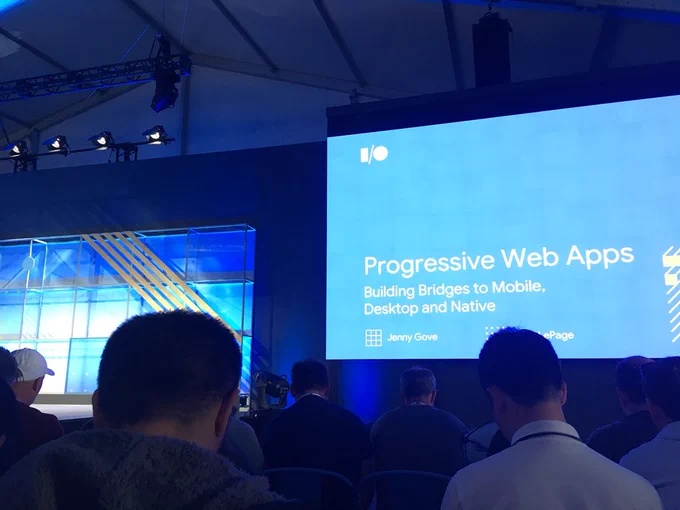 A shot of the stage with opening title slide on screen.