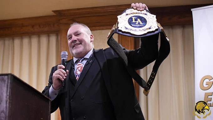 Coach Vince holds the pick up champ belt.