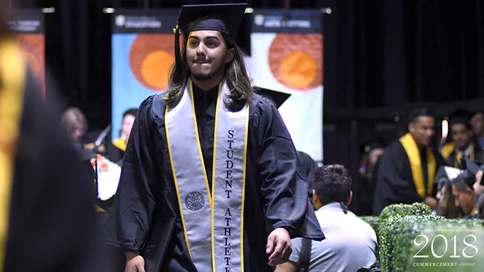 Paul Martinez walks down the isle after getting his degree.