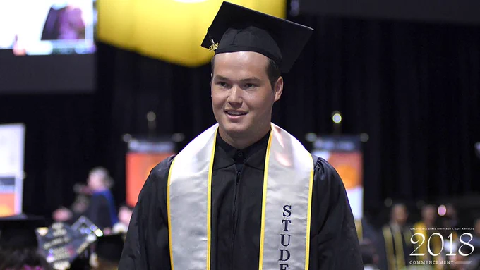 Ryan Welker walks down the isle after getting his degree.
