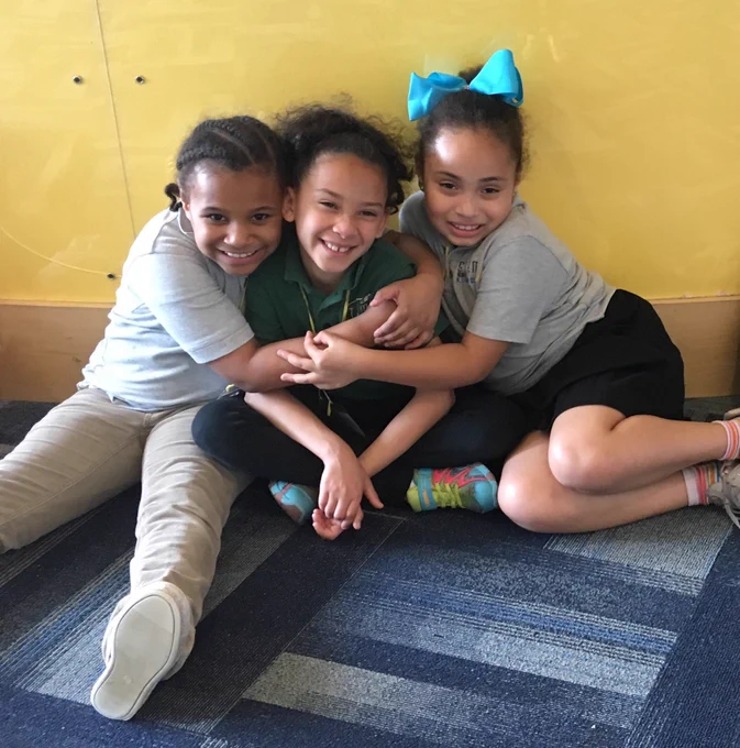 students hugging at the end of a field trip