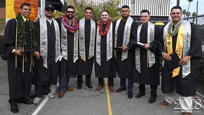 Baseball grads pose together.