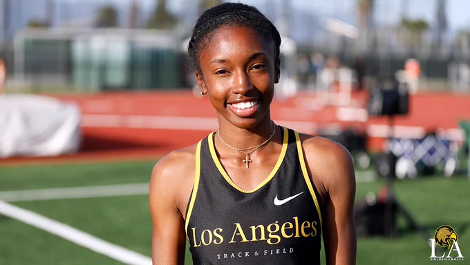 Track athlete Ericka Taylor smiles at the camera.