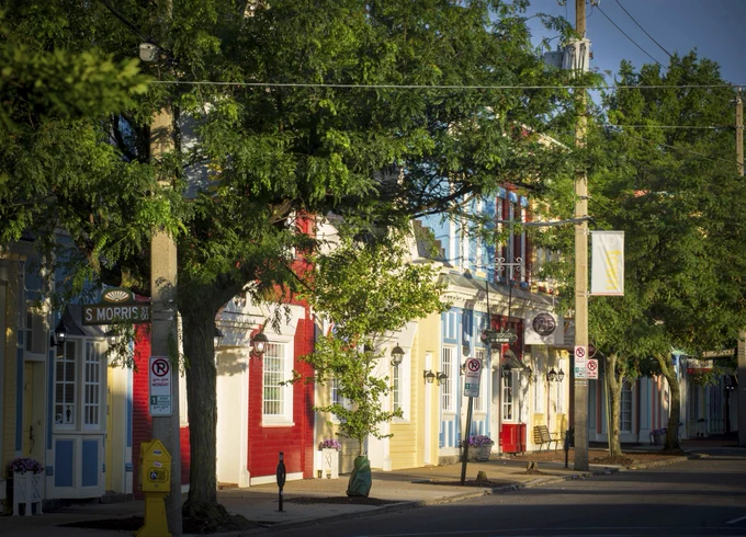 Image Description: The early summer sun illuminates a row of brightly colored stores along Main Street near VCU's Monroe Park campus.