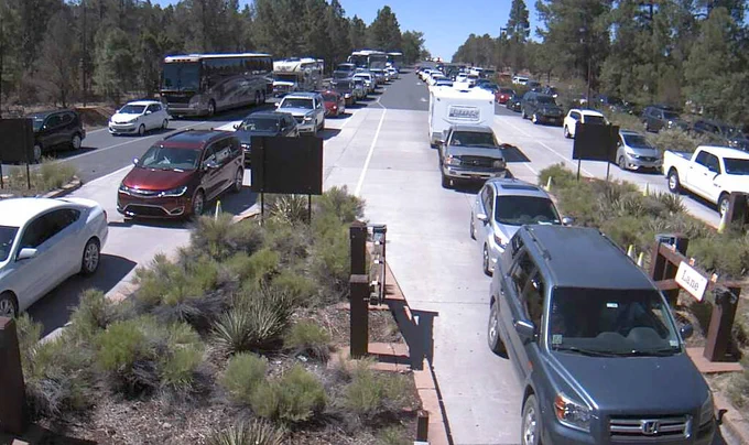 Image description: five long lines of cars waiting to buy an entrance pass and enter Grand Canyon National Park.