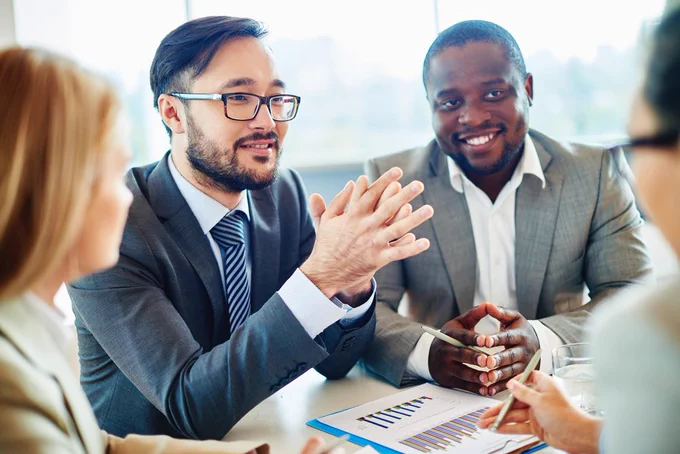 Group of business people sitting at table.