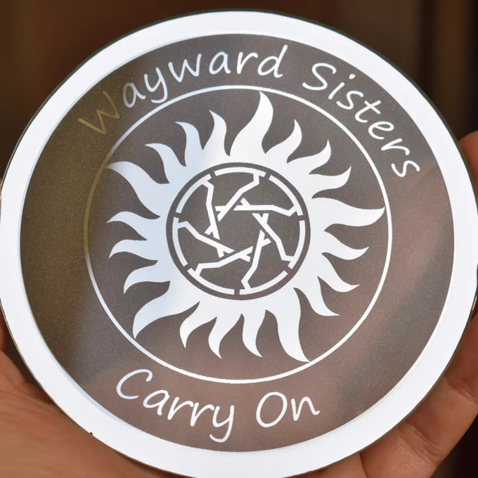 Wayward Sisters logo laser engraved on the back of a 5 inch round mirror