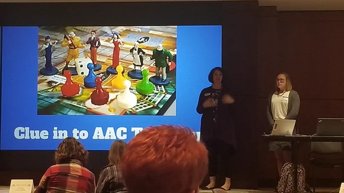 two ladies presenting to a crowd