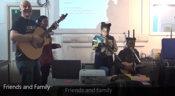 tutors and young people performing a brand new specially written song