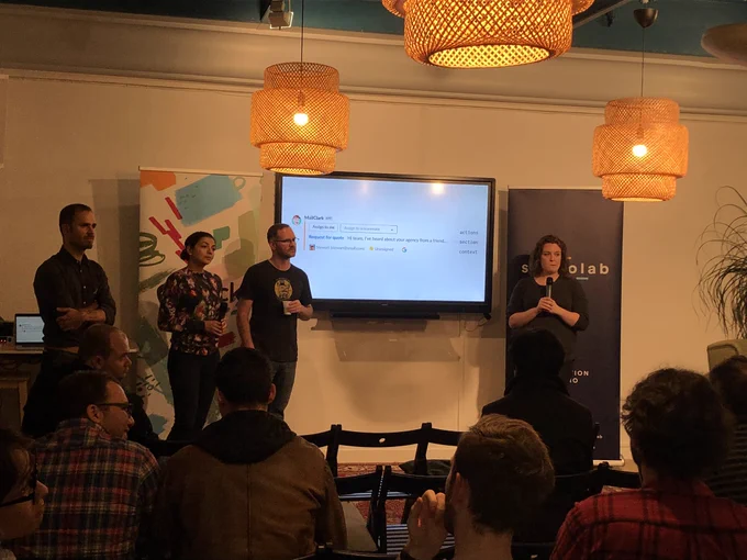 The Slack team answers questions alongside MailClark after the event. Two men and two women at the front of the room with a screen behind them.