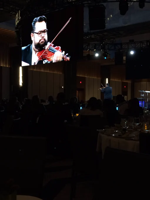 Vijay Gupta playing the violin onstage