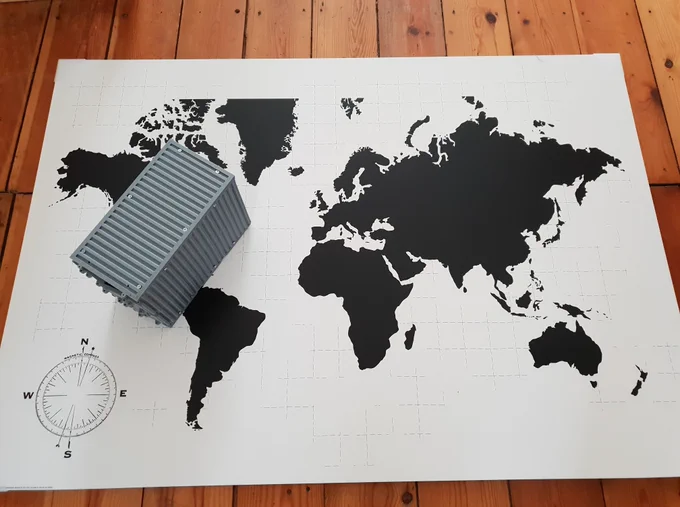 A miniature connected smart container and a world map