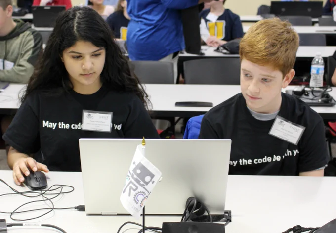 Two students participating in the Cyber Robotics Coding Competition