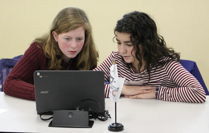 Two students participating in the Cyber Robotics Coding Competition